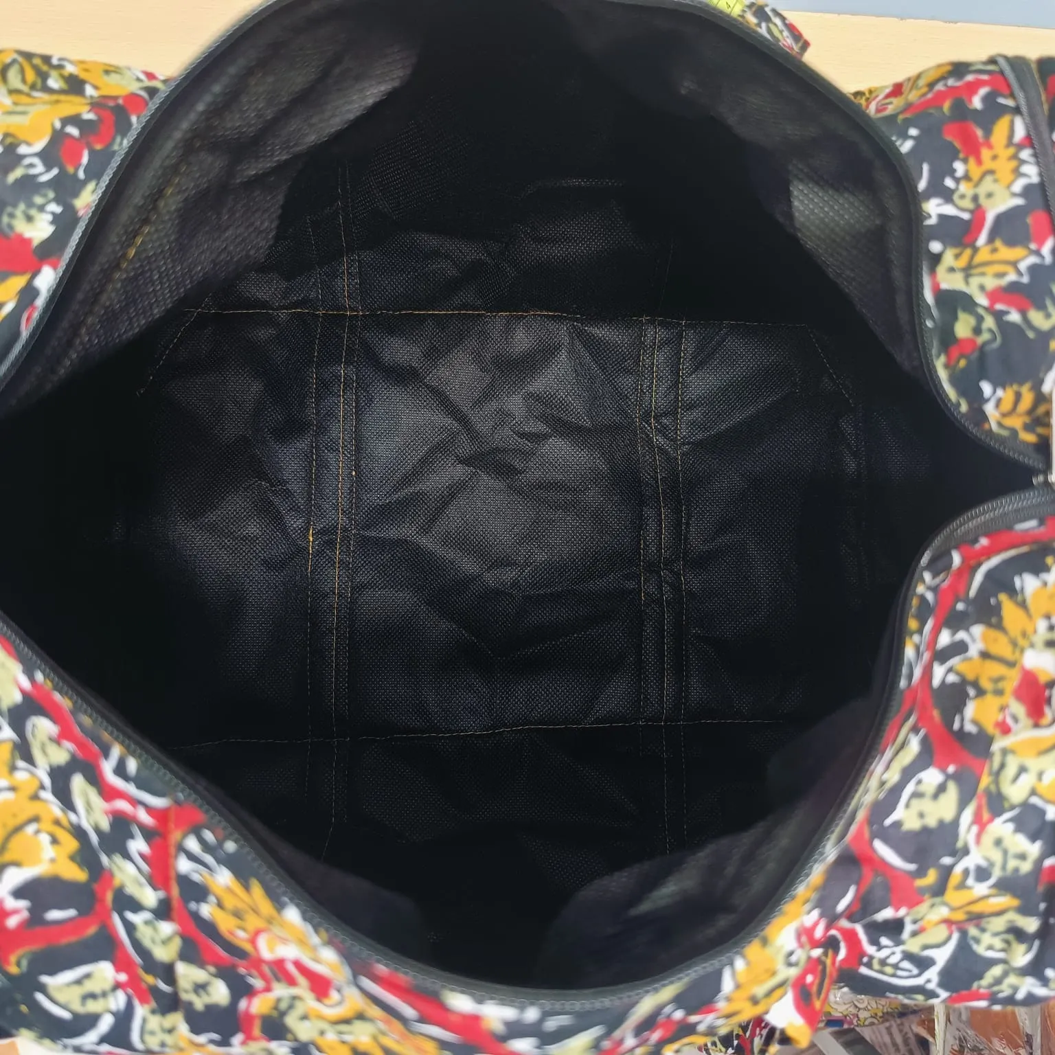 Expandable Travel Bag  Brown Colour with Red Graphic Design.