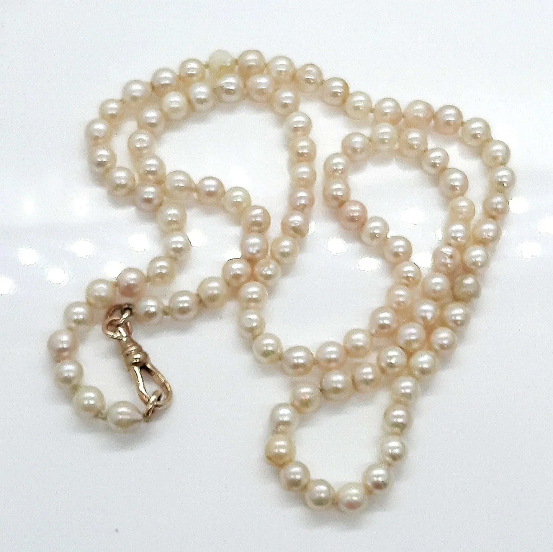 Strand of 99 Cultured Pearls with a Yellow Gold Albert Swivel Clasp